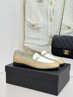 Chanel women's loafers in cream and white with gold buckle strap