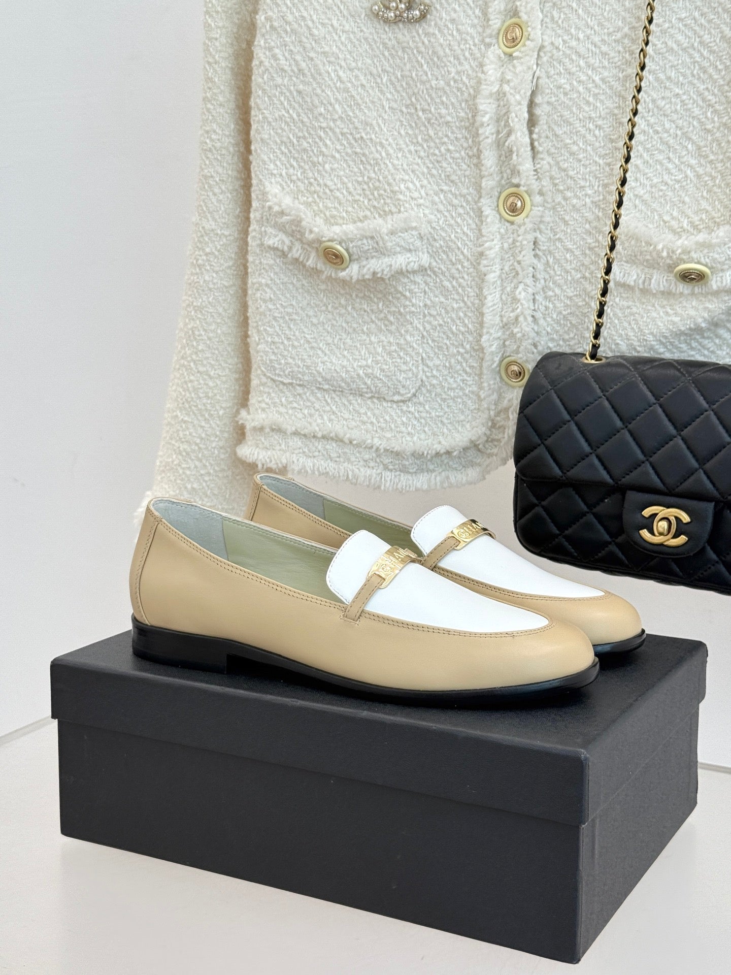 Chanel women's loafers in cream and white with gold buckle strap