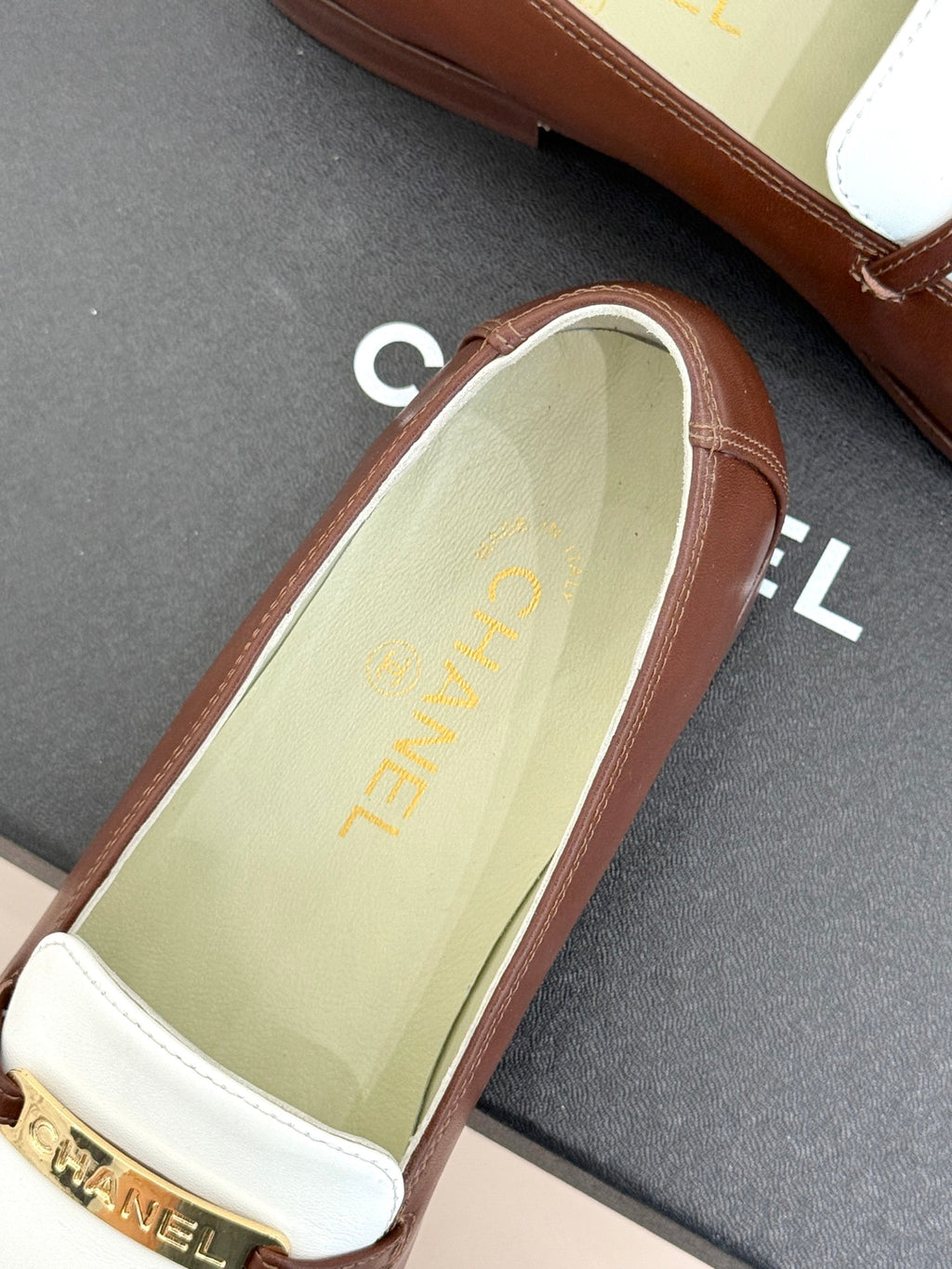 Chanel ladies luxury loafer close-up, light green insole with gold text