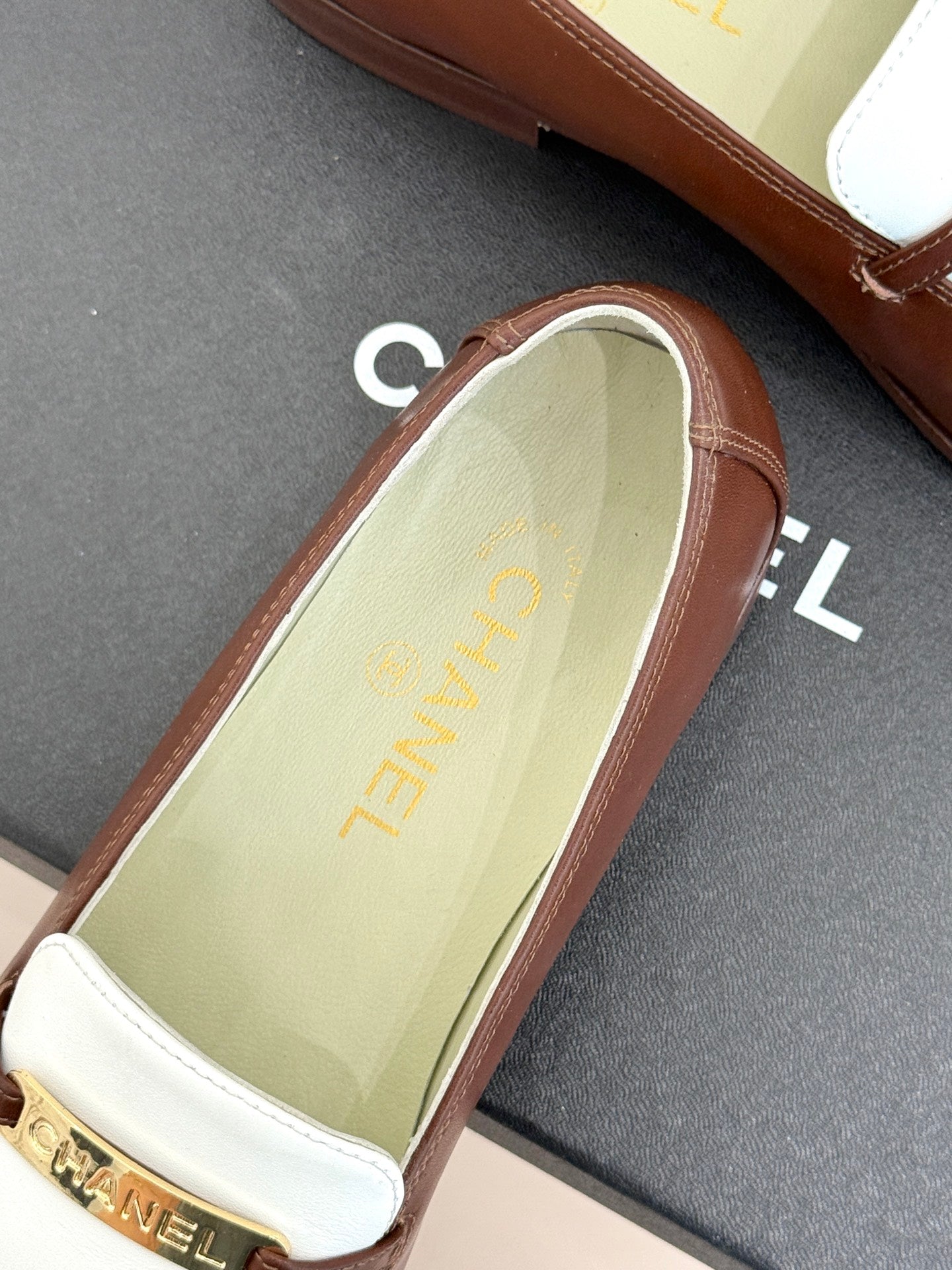 Chanel ladies luxury loafer close-up, light green insole with gold text