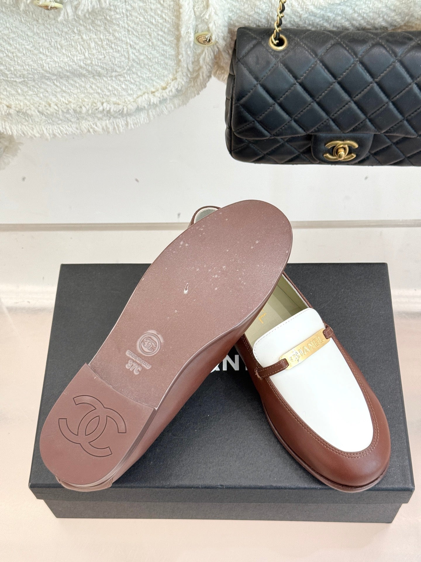 Chanel ladies luxury loafer, brown sole and white strap with gold buckle