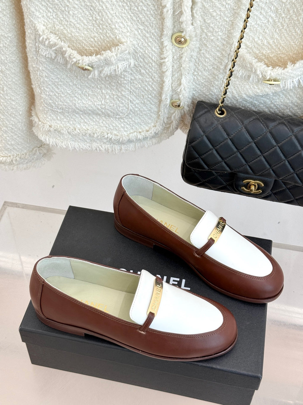 Chanel ladies luxury loafers, brown and white with gold buckle, on shoe boxes