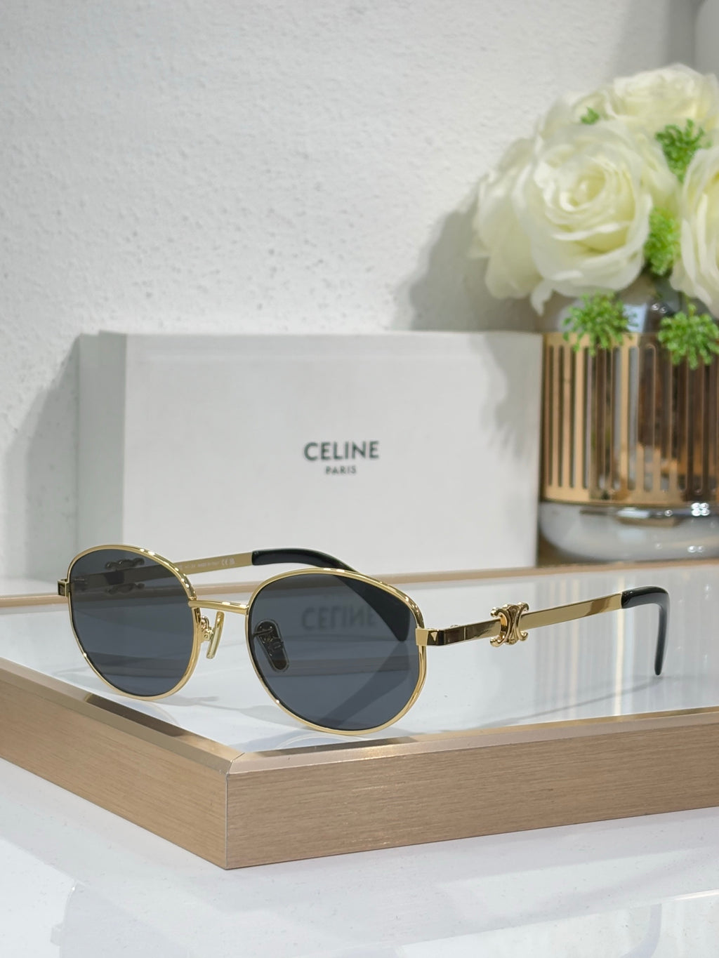 Gold round sunglasses with dark lenses and ornate metal bridge
