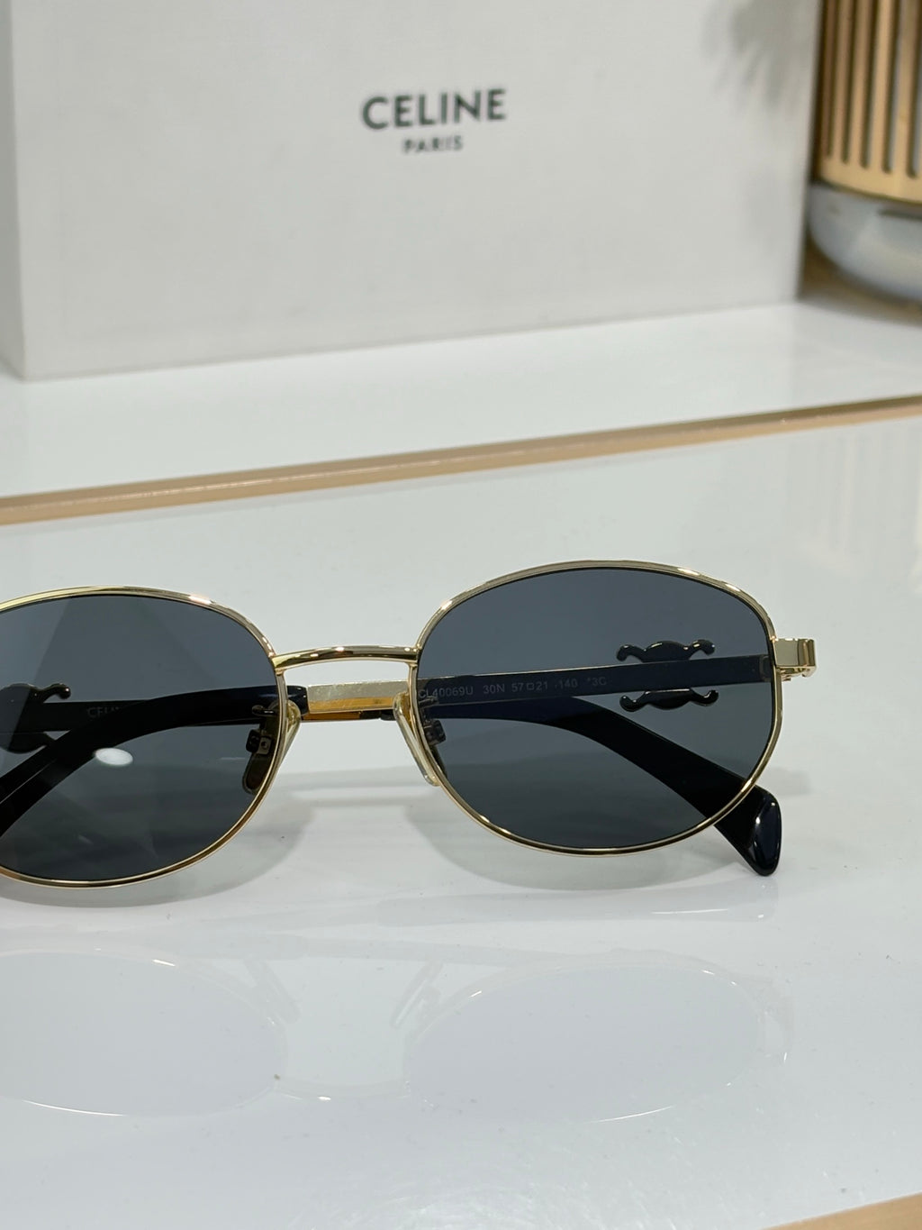 Black round sunglasses with dark lenses and silver-tone temple details