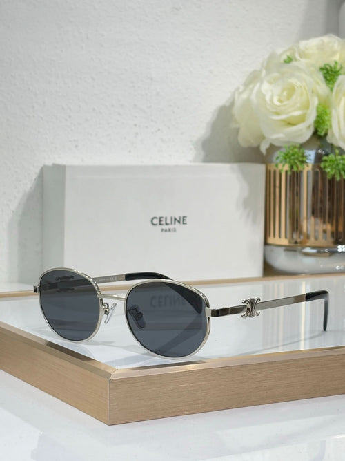 Black and gold round sunglasses with dark lenses and side hinge detail