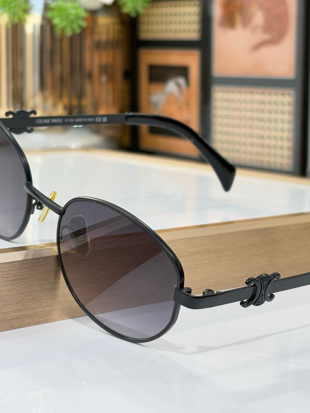 Black round sunglasses with dark gradient lenses and curved temple arms