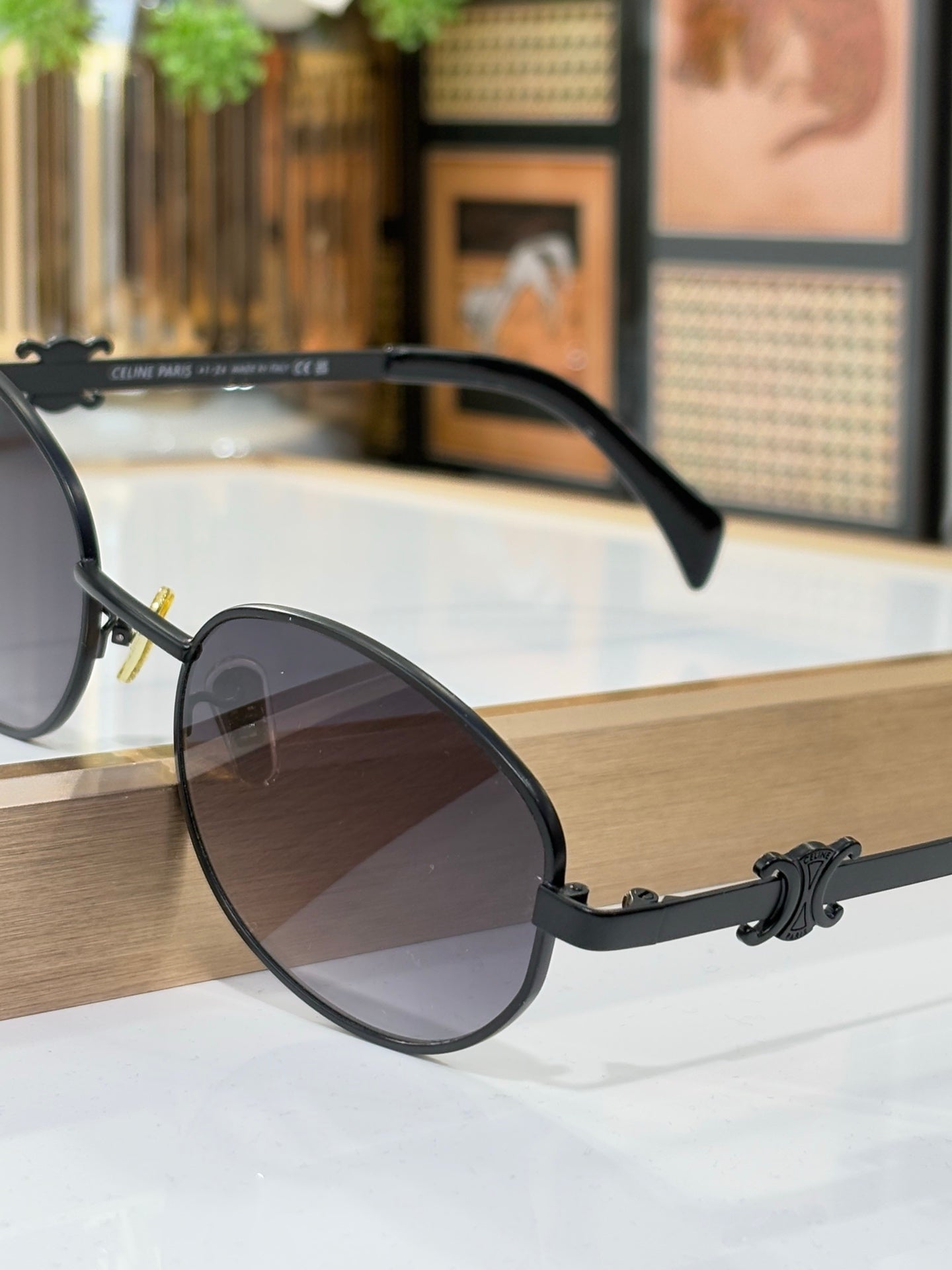 Black round sunglasses with dark gradient lenses and curved temple arms