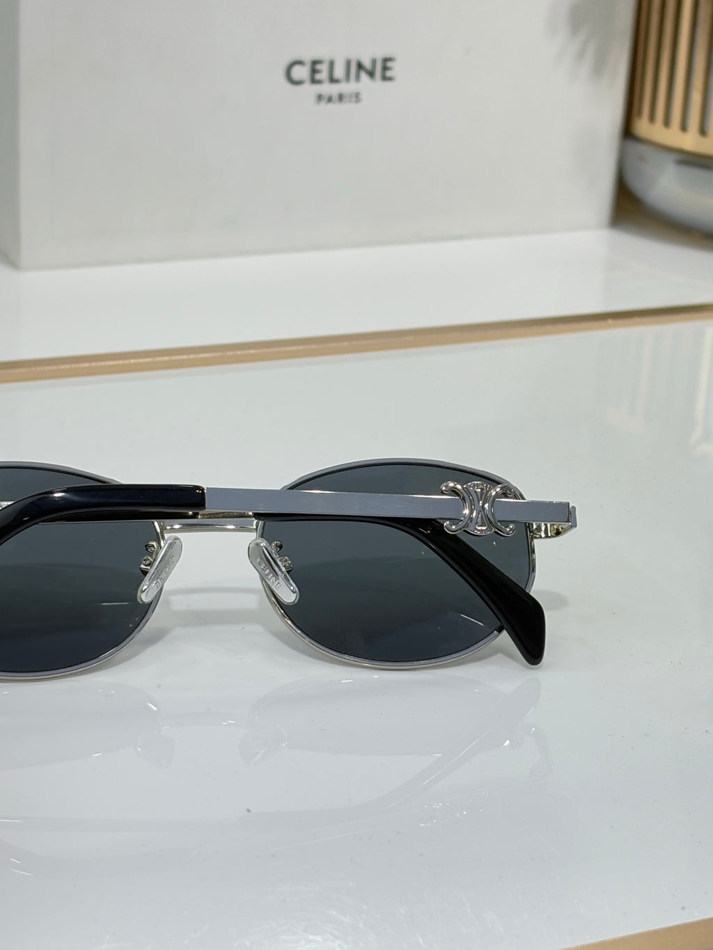 Black round sunglasses with dark lenses and metal hinge hardware
