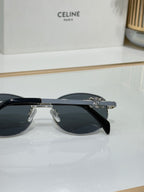 Black round sunglasses with dark lenses and metal hinge hardware
