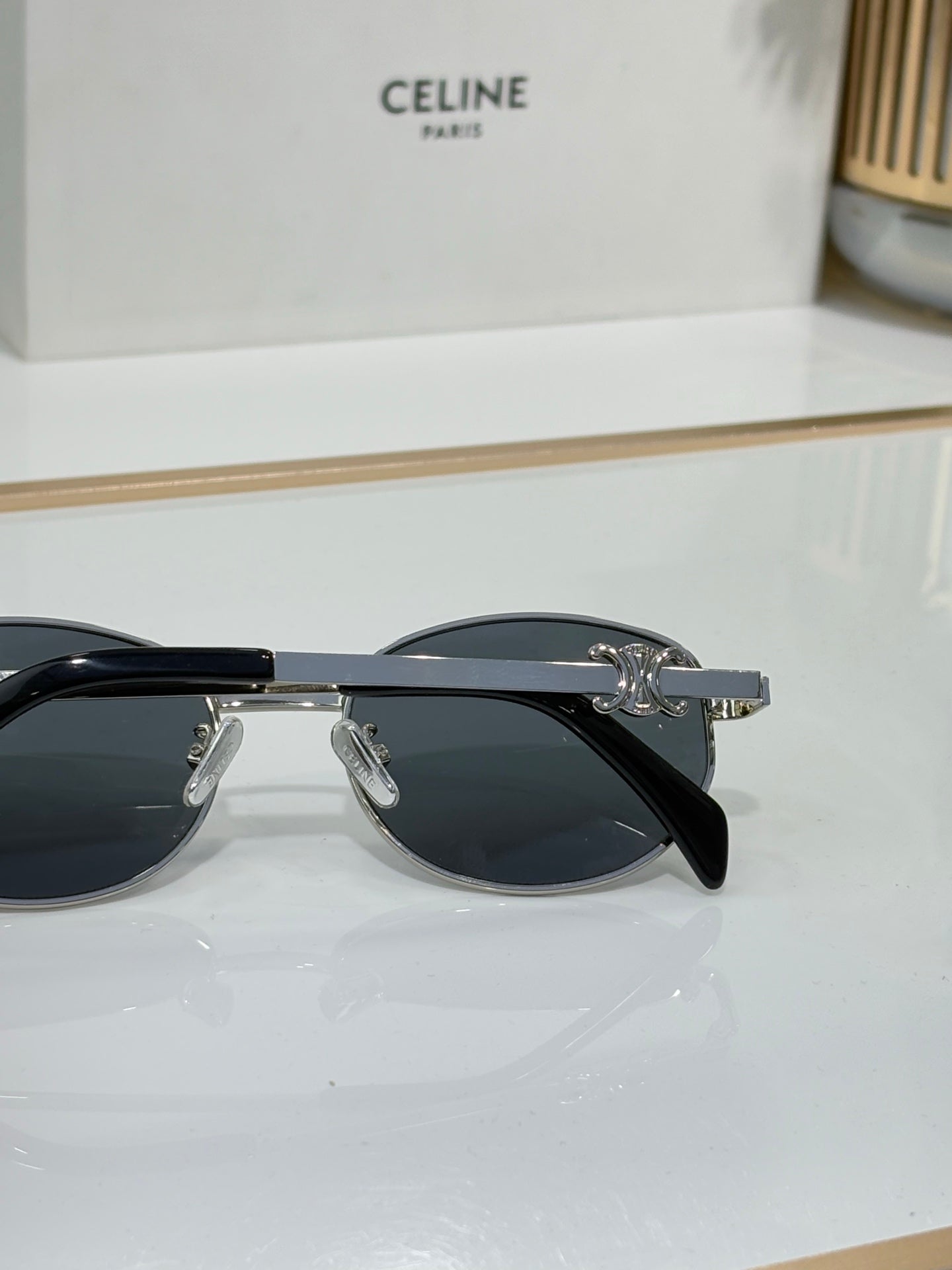 Black round sunglasses with dark lenses and metal hinge hardware