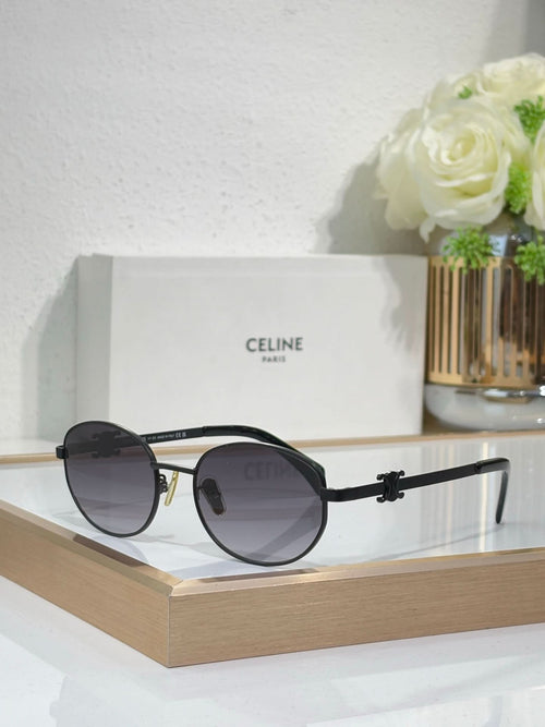 Black and gold round sunglasses with dark lenses and metal arms