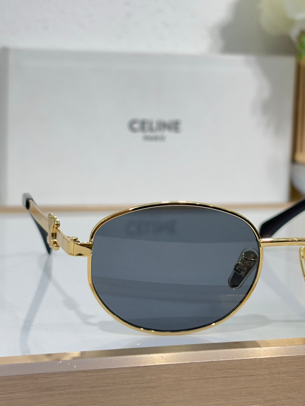 Celine round sunglasses with gold frame and dark lenses, gold temple details