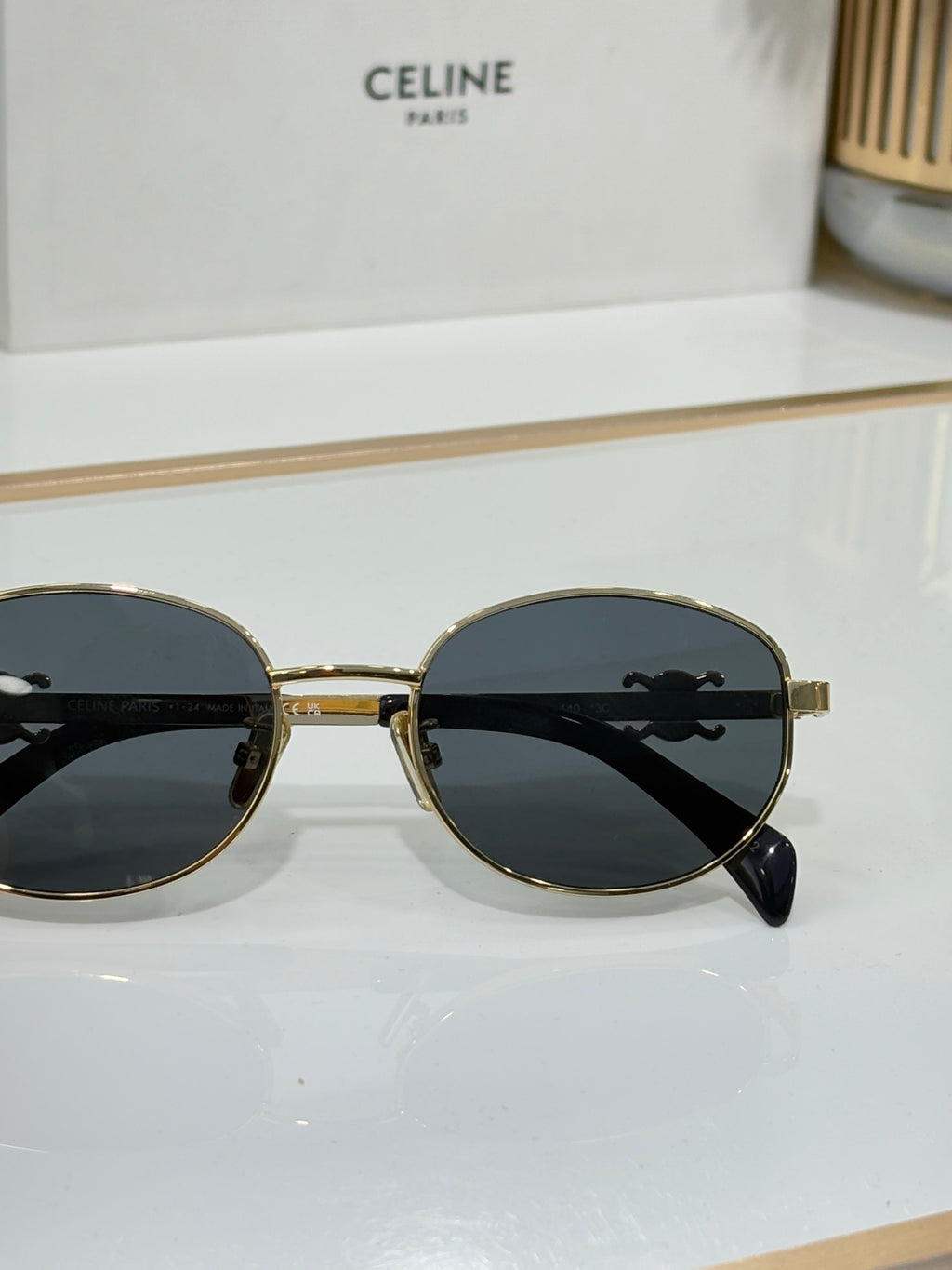 Celine round sunglasses with gold bridge and dark lenses, front view
