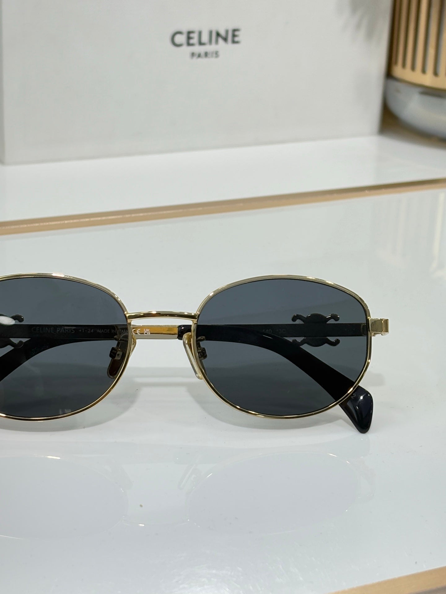 Celine round sunglasses with gold bridge and dark lenses, front view
