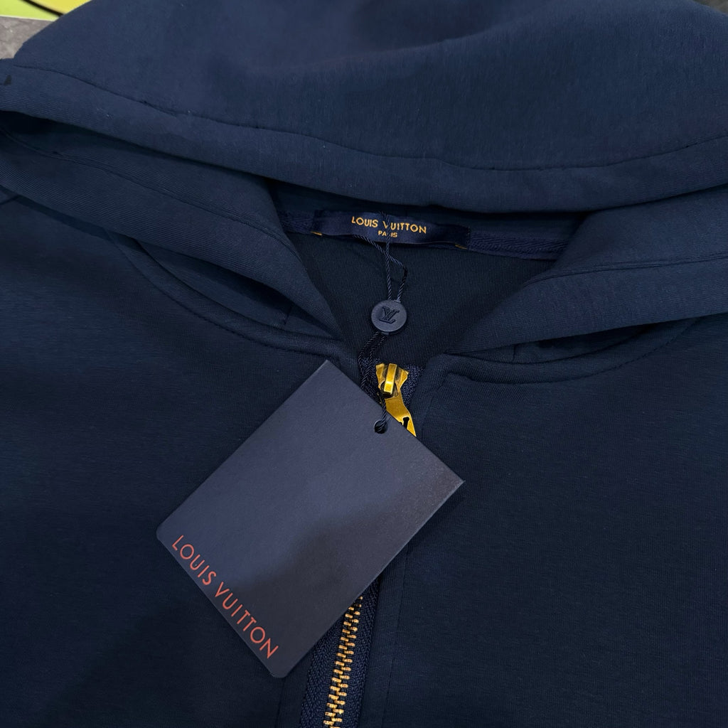 Navy Louis Vuitton hoodie with hood, gold zipper, and hanging price tag