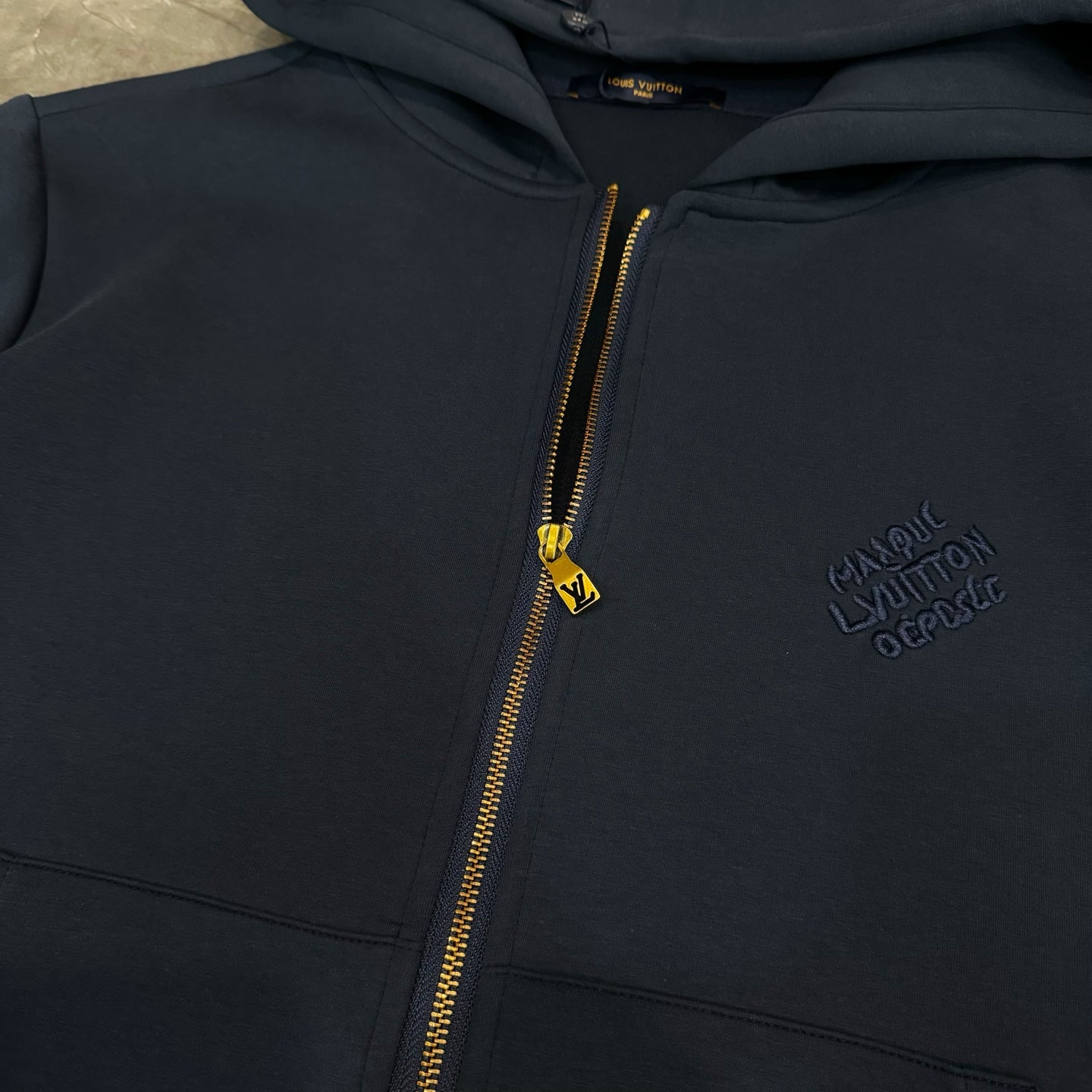 Navy Louis Vuitton zip-up hoodie with gold zipper and gold LV zipper pull