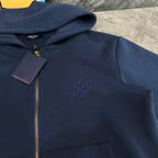 Navy Louis Vuitton zip-up hoodie with hood, small chest logo, and front pocket