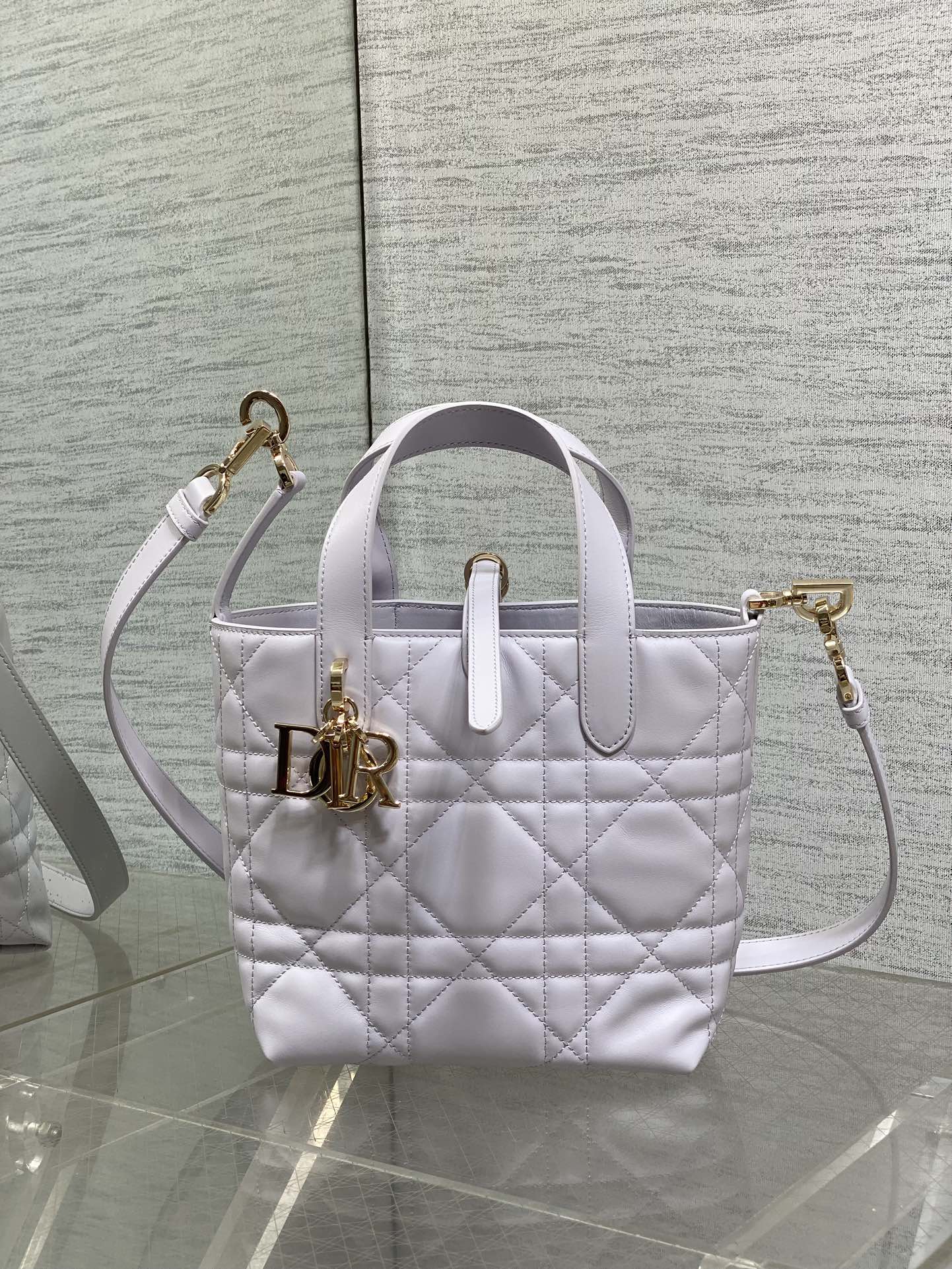 Dior quilted mini handbag with detachable shoulder strap and gold tone logo charm