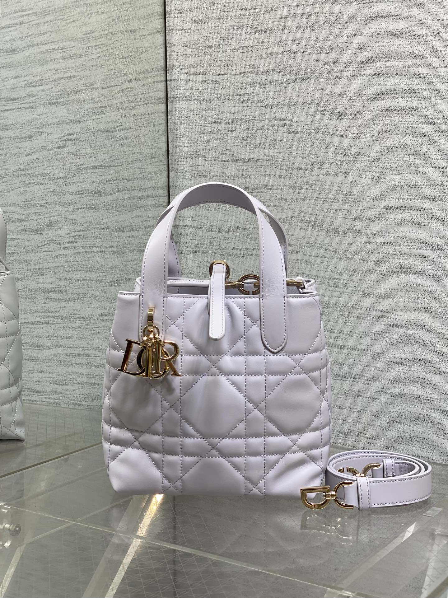 Dior quilted mini handbag in light white with top handle and gold logo hardware