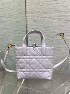 Dior quilted mini handbag with top handle and crossbody strap in light white