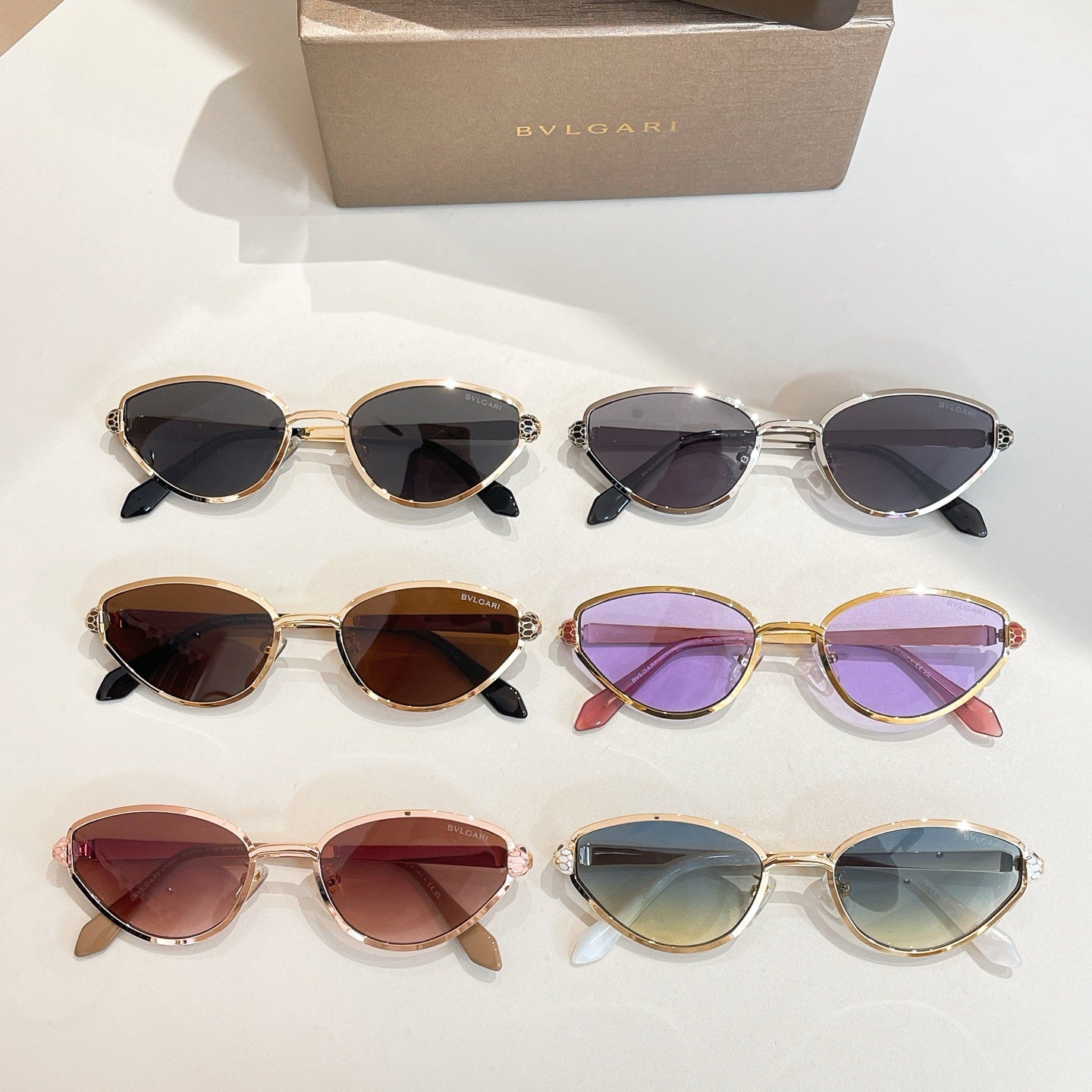 BVLGARI cat-eye sunglasses set showing mixed gold frames and colored tinted lenses