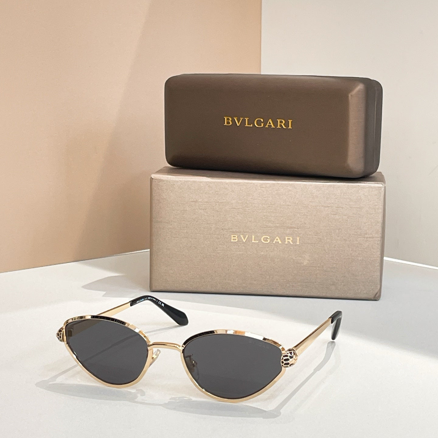 BVLGARI cat-eye sunglasses with gold frame and dark gray tinted lenses