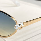 BVLGARI cat-eye sunglasses close-up: gold hinge with soccer-ball emblem