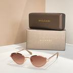 BVLGARI cat-eye sunglasses with gold frame and rose-pink tinted lenses