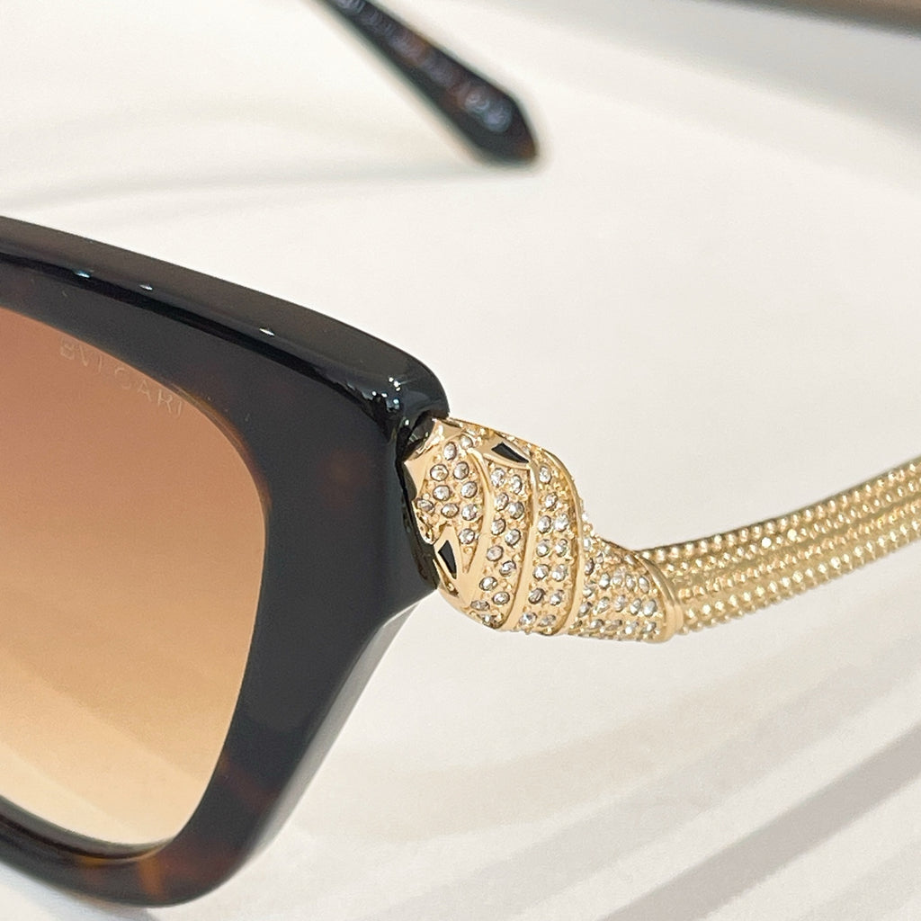 Bvlgari sunglasses with glossy dark frame and gold rhinestone temple detail