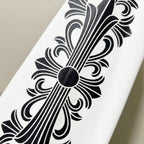 Close-up of black decorative floral line art on white sweatshirt sleeve