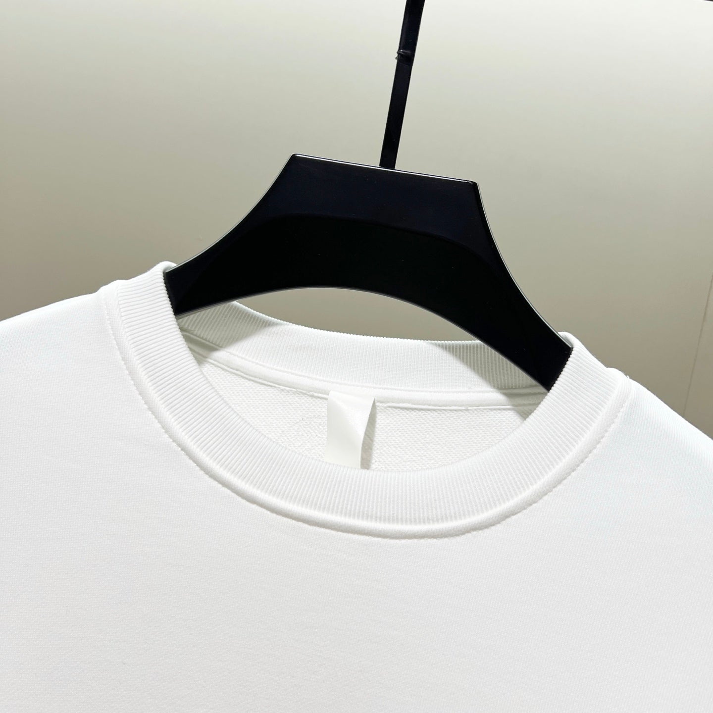 White crewneck sweatshirt collar with ribbed neckline detail