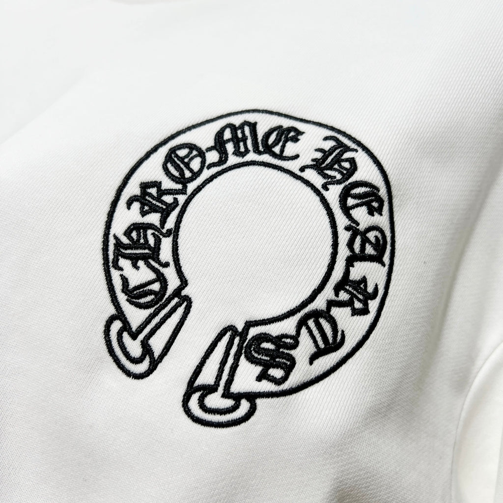 White sweatshirt chest graphic: circular black logo print