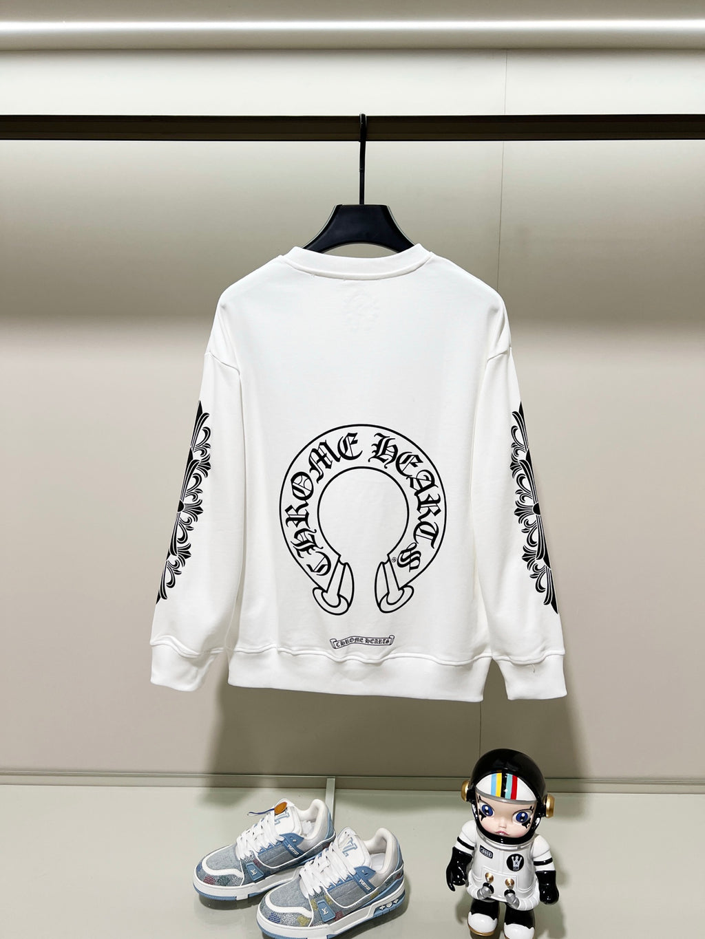 White sweatshirt with back center logo and black patterned sleeve prints