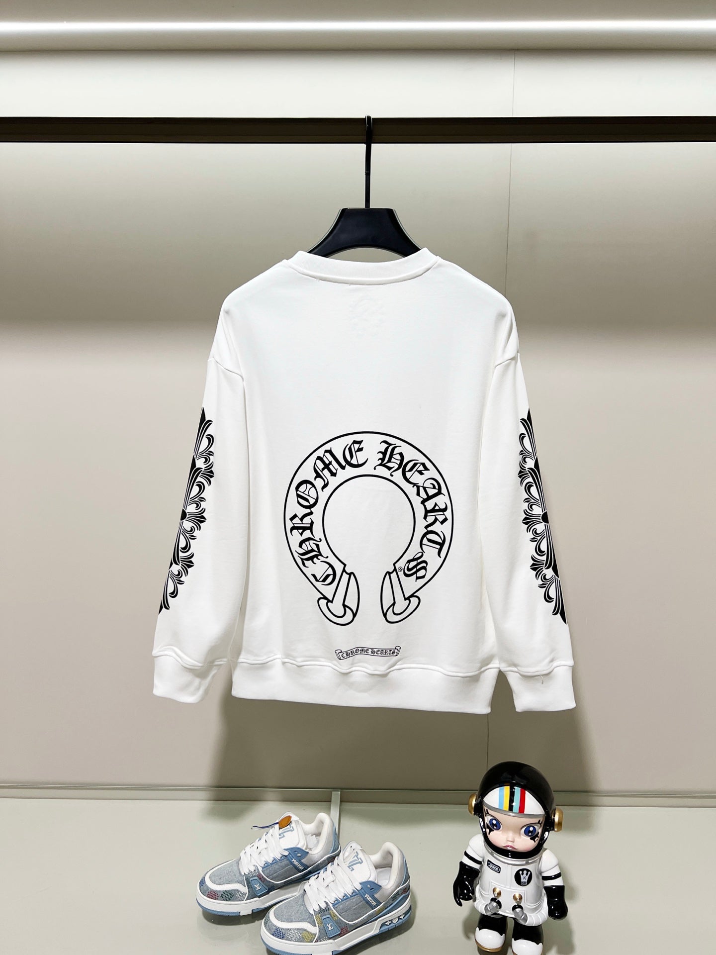 White sweatshirt with back center logo and black patterned sleeve prints