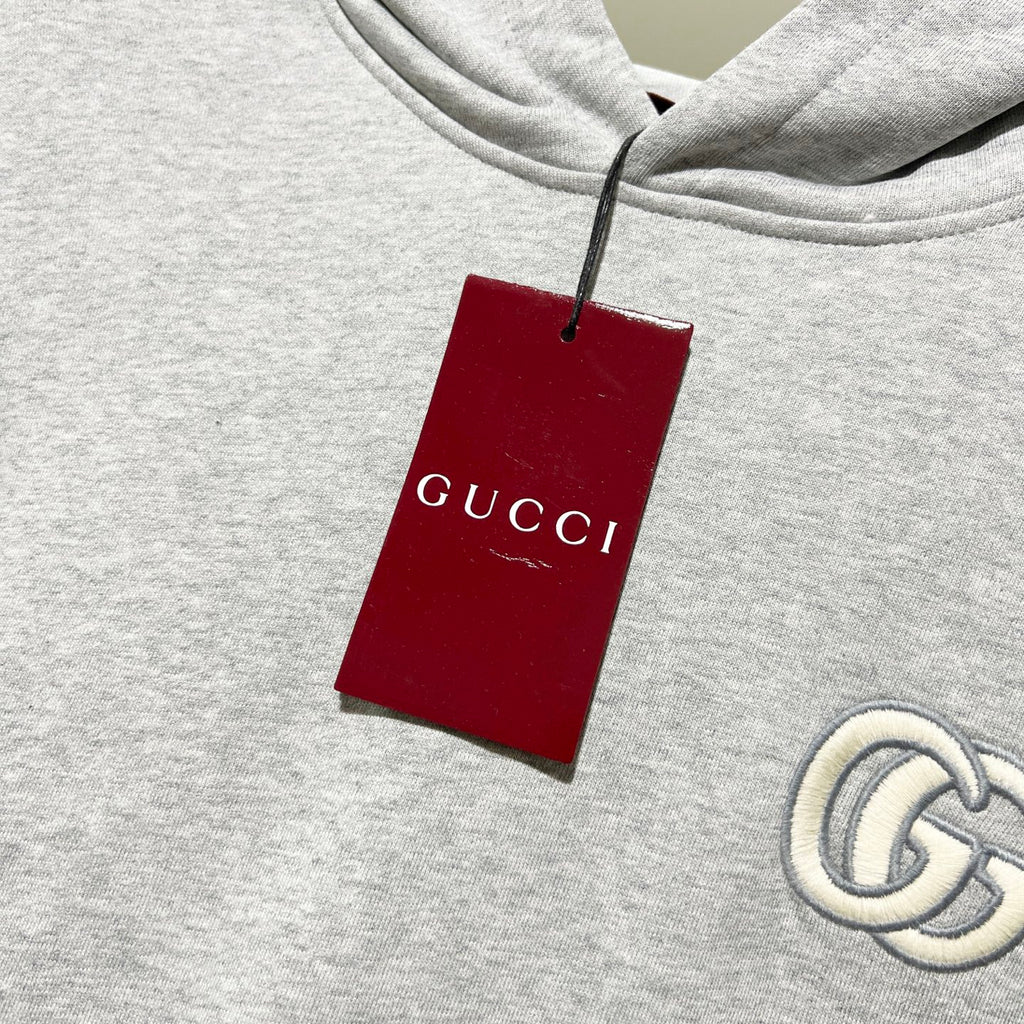Gucci long-sleeve hoodie with red hanging tag at neckline, heather gray knit fabric