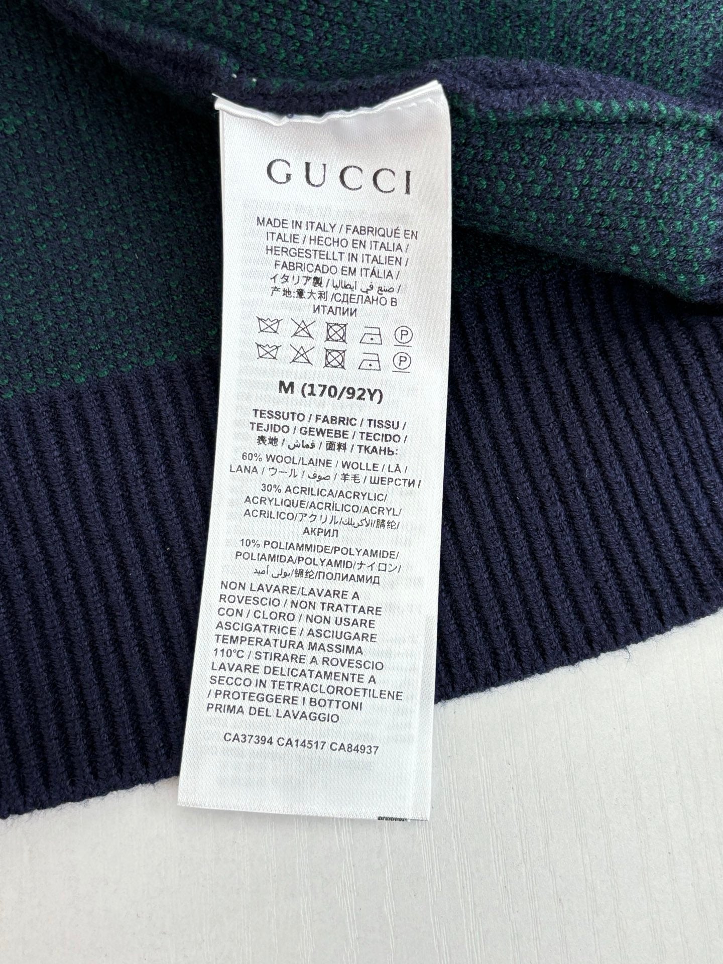 Gucci long cardigan care label on green and navy GG jacquard knit fabric