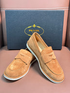 Prada unisex tan suede loafers, side and heel views with white rubber soles.