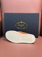 Prada unisex tan suede loafer outsole with textured white rubber tread.
