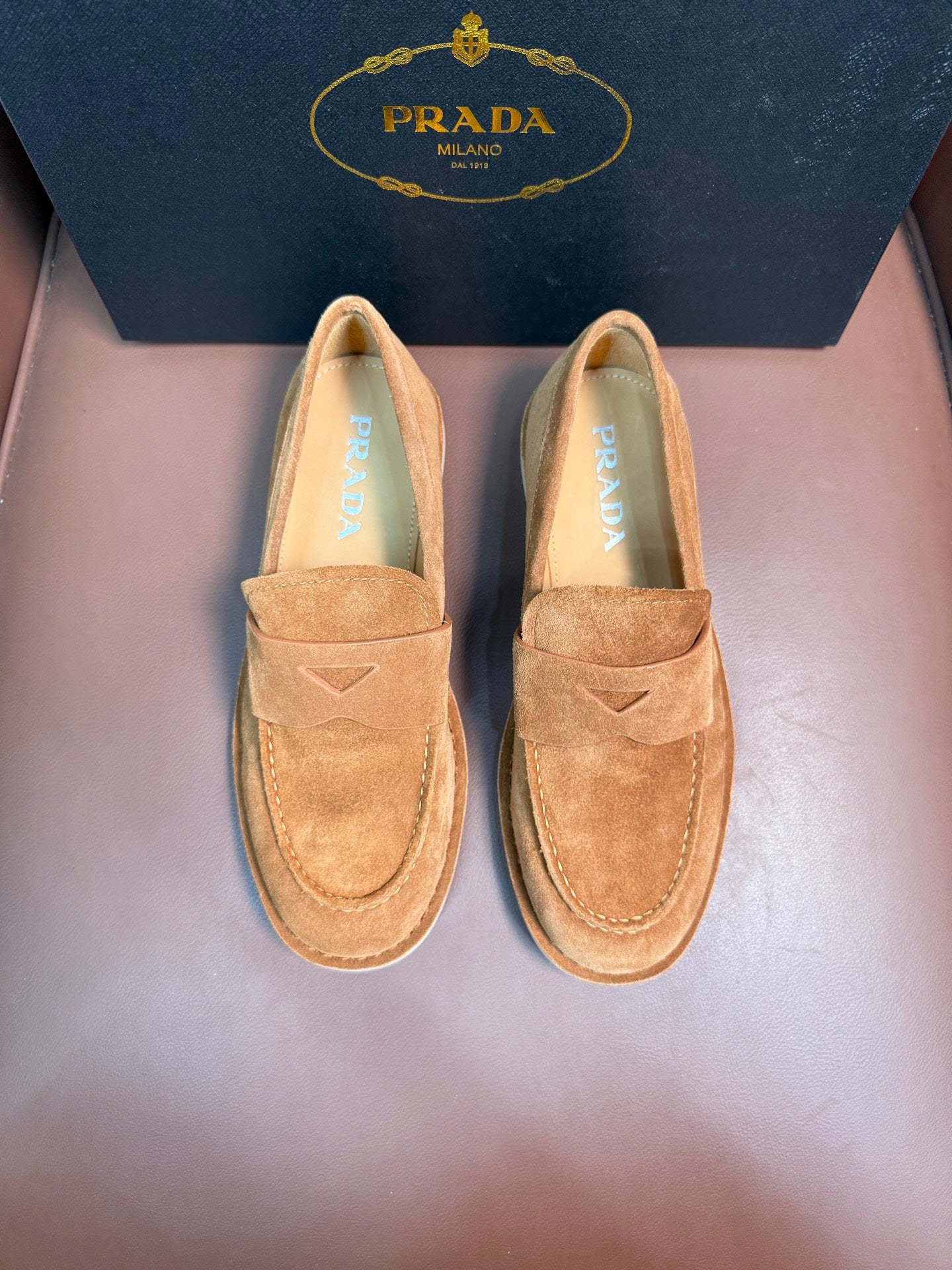 Prada unisex tan suede loafers, slip-on design with triangular logo on vamp.