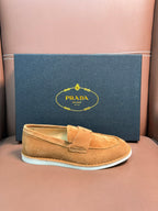 Prada unisex tan suede loafer with white rubber sole, boxed presentation.