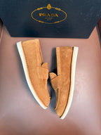 Prada unisex tan suede loafers with white rubber soles, angled top view pair.