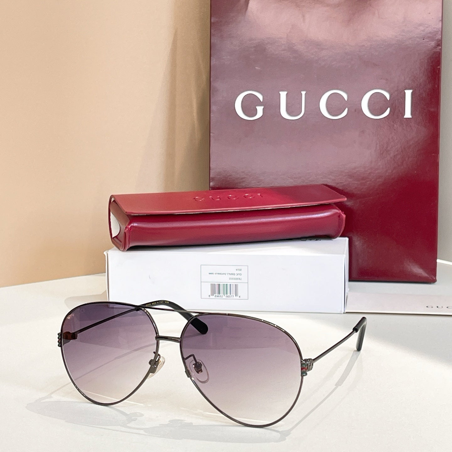 Dark metal round sunglasses with tinted purple lenses and slim straight arms