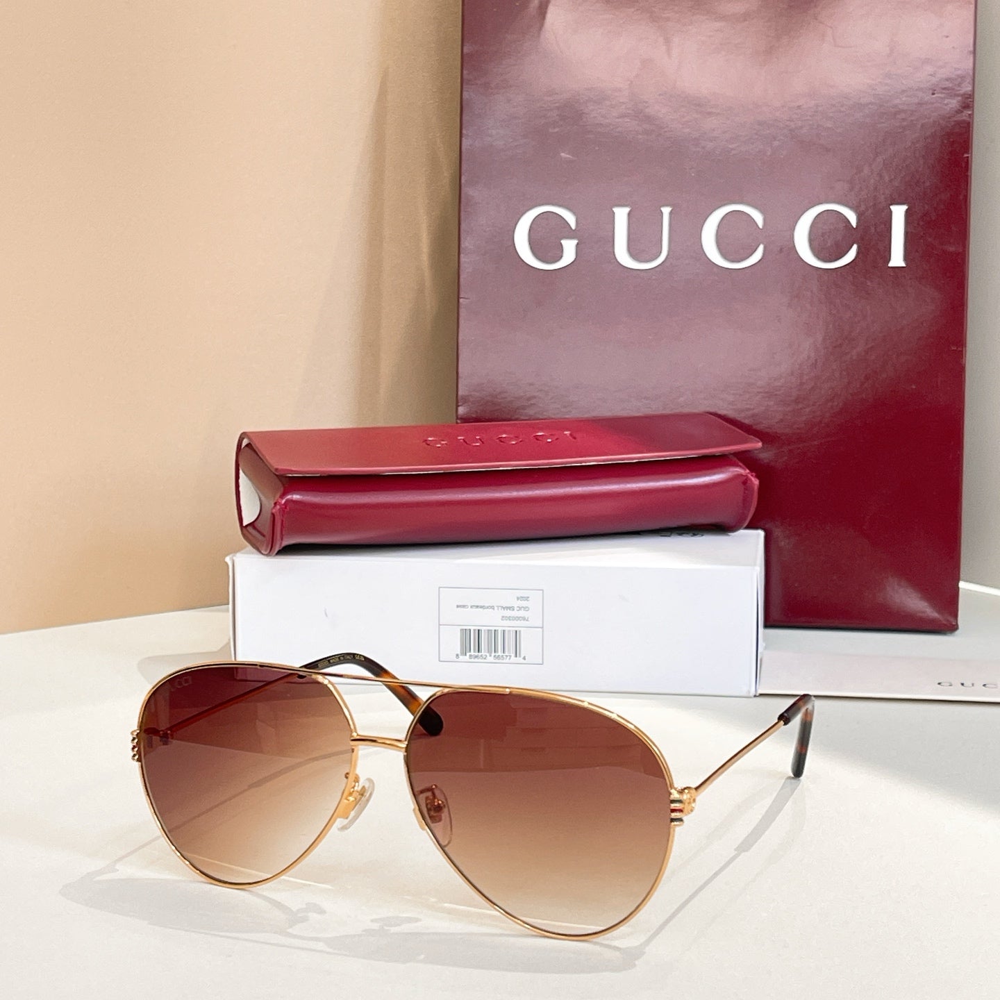 Gold-tone round sunglasses with amber tinted lenses and thin metal arms