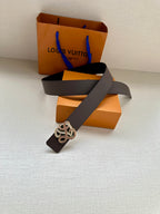 Dark navy leather belt with gold-tone monogram buckle and folded strap end