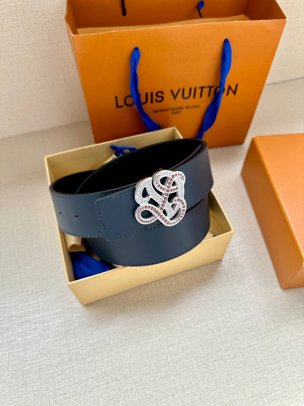 Dark blue leather belt with silver-tone and colorful logo buckle