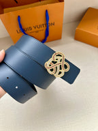Dark blue leather belt strap held up with jeweled logo buckle