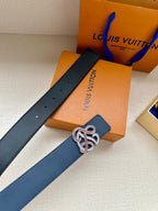 Dark blue leather belt with perforated strap and jeweled logo buckle