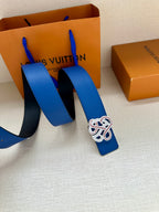 Blue leather belt with ornate buckle and extended strap ends