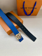 Leather belts in navy and blue with ornate buckle emblems