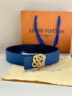 Blue leather belt with ornate gold and silver buckle and strap keeper